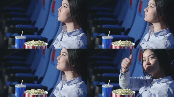 亚洲女孩在电影院竖起大拇指