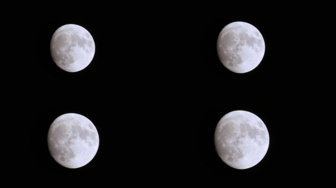 超级月亮开始升起并向满月开放，在前景后面轻轻地变焦掠过