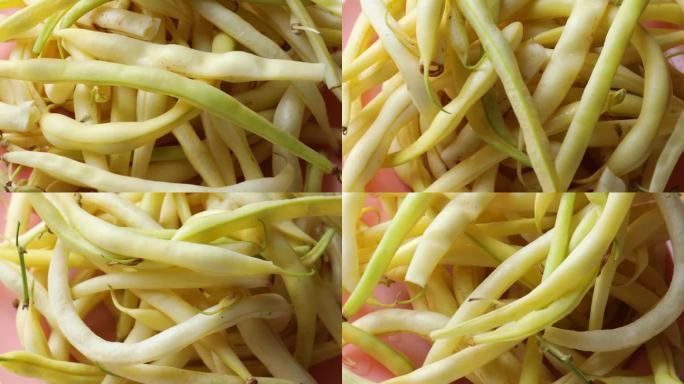 黄芦笋豆，绕圈旋转。新鲜豆荚，芦笋，翻盘。