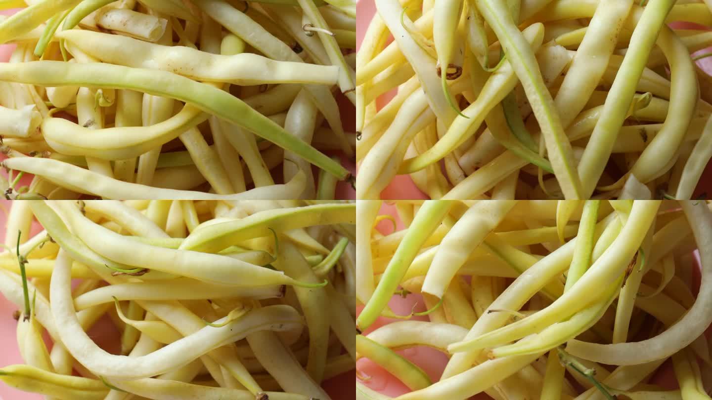 黄芦笋豆，绕圈旋转。新鲜豆荚，芦笋，翻盘。