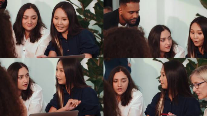 工作场所的多样性。富有魅力的年轻亚洲创意经理在笔记本电脑上向不同的同事展示演示