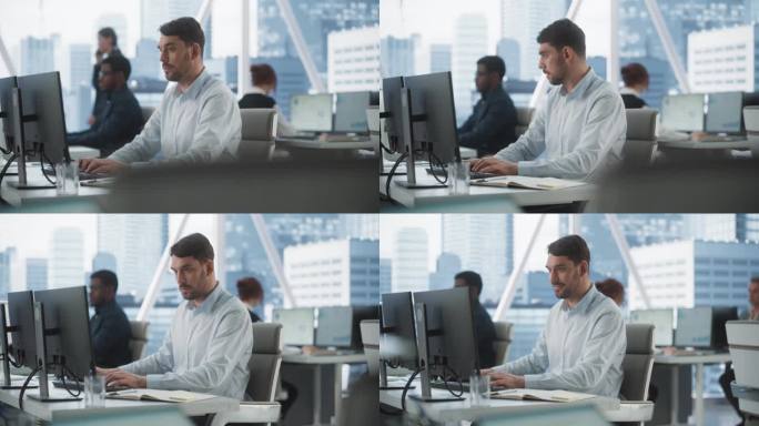 快乐的男性客户经理在不同公司办公室的台式电脑上打字，拥有大都市的窗口视图。专业的白种人为咨询公司做笔