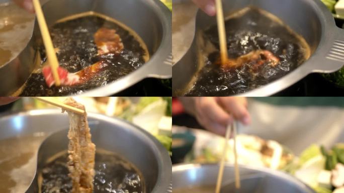 用筷子夹肉、牛肉片在滚烫的火锅汤中烹煮的蔬菜火锅特写。日本亚洲美味健康火锅涮食品