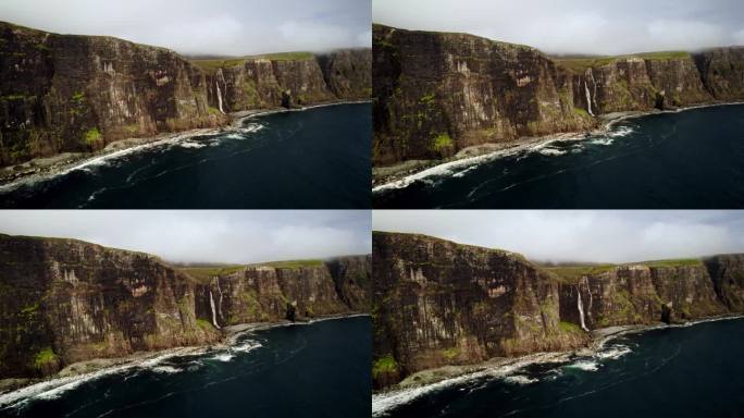 令人叹为观止的瀑布从长满青苔的绿色悬崖倾泻入海，苏格兰天空