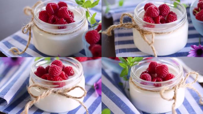 甜美的自制酸奶与新鲜的覆盆子在一个玻璃罐中。
