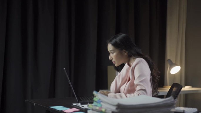 亚洲女商人有手臂痛，肩膀痛，脖子痛，压力和疲劳，因为长时间使用笔记本电脑工作，她有办公室综合症，工作
