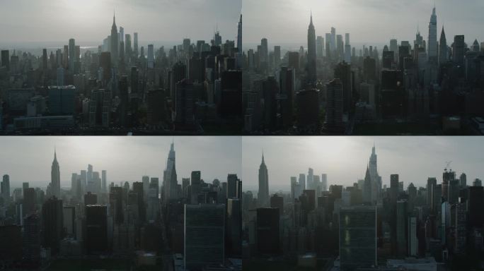 穆迪电影航拍黄昏镜头曼哈顿下城繁忙拥挤的城市街道与汽车交通。在轻雾霾中的办公大楼和摩天大楼的全景直升