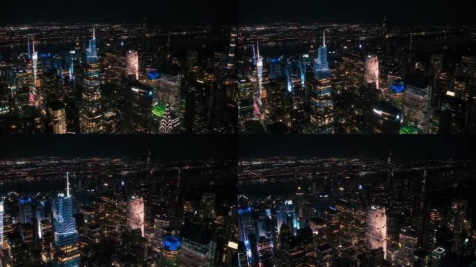 办公楼夜间航拍画面。在纽约，房间里亮着灯，商人和经理们长时间工作。直升机俯瞰曼哈顿的夜景