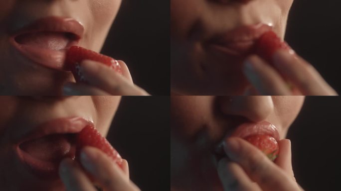 美丽的性感女人用红色的口红工作室拍摄咬一口草莓水果和品尝