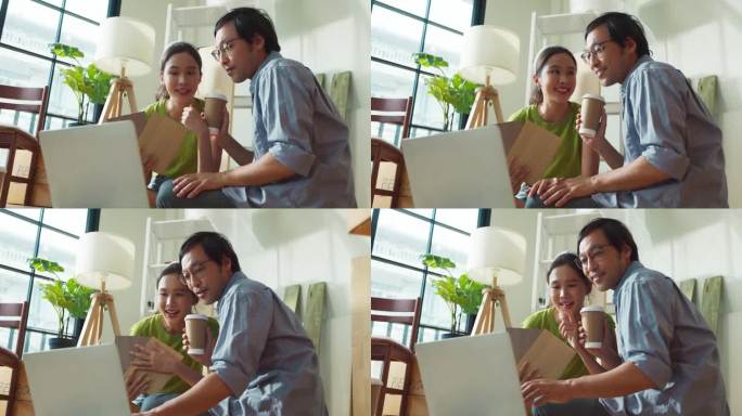 亚洲快乐的年轻夫妇在新公寓休息期间坐在家中装修配件，家庭搬迁装修室内概念，幸福夫妇粉刷墙壁