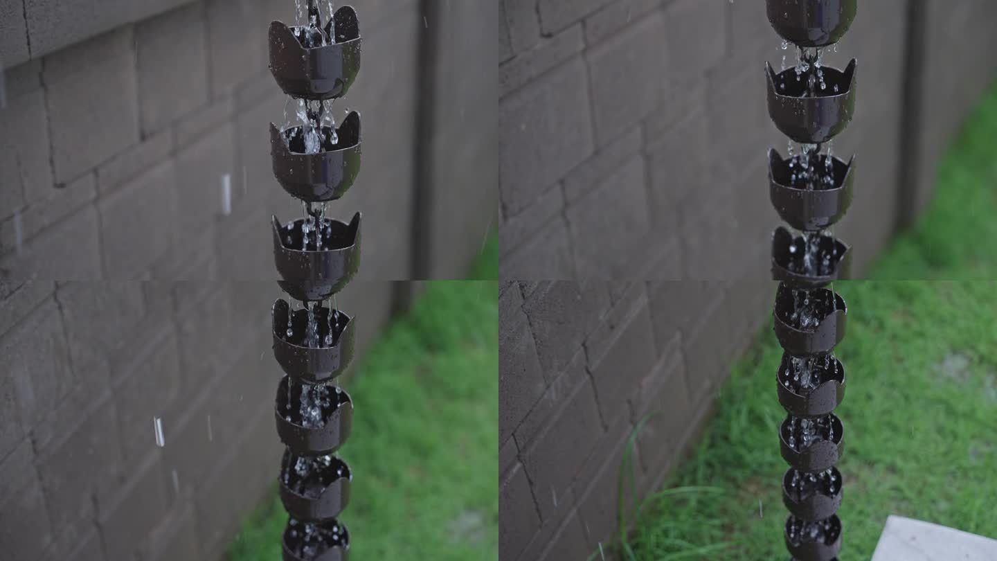 SLO MO:倾斜向下拍摄的装饰钟形金属雨链连接到屋檐上的排水沟，雨水从上到下流下来。