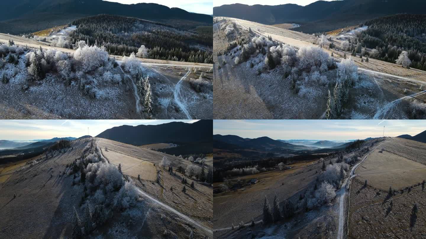 冬季森林自然白雪覆盖的冬季树木高山景观清晨日出假日旅游霜冻的树顶鲜艳的色彩空中4k