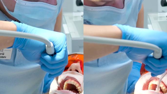 液体围堰隔离牙龈水喷射和唾液喷出女病人戴防护眼镜与光聚合物灯工作的医生和护士戴蓝色手套