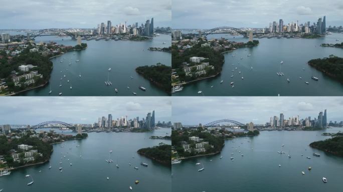 在悉尼Berrys湾，悉尼海港大桥，环形码头和悉尼达令港办公室和豪华大楼群上着陆的4K鸟瞰图实时镜头