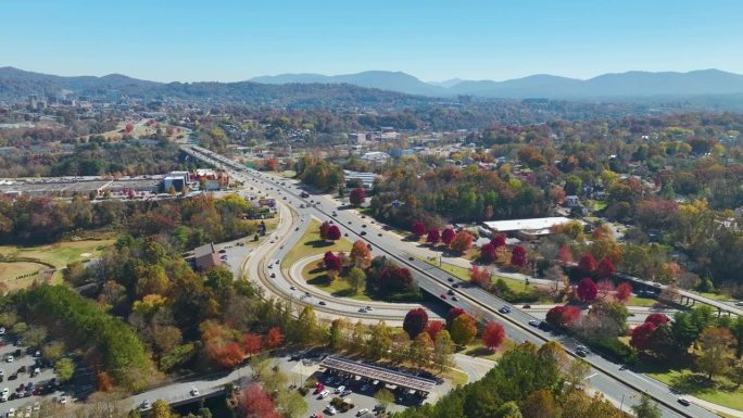 北卡罗莱纳州阿什维尔的秋季美国高速公路交叉口鸟瞰图，高速行驶的汽车和卡车。美国交通基础设施概念