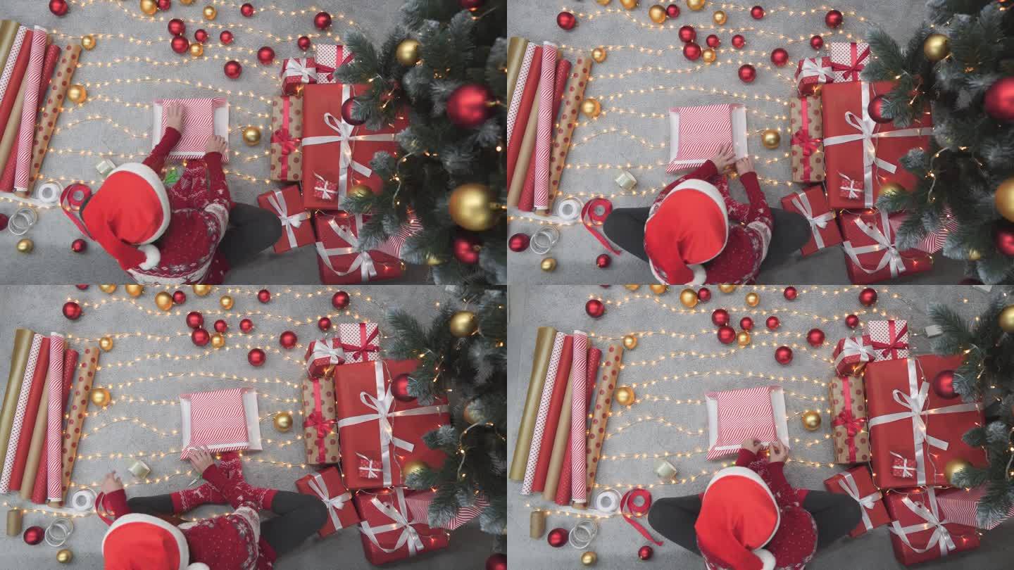 在圣诞节的气氛中，一个女人假装包装每个盒子，创造充满爱和温柔的礼物。在圣诞树的嘴下，一个女人勤奋地用