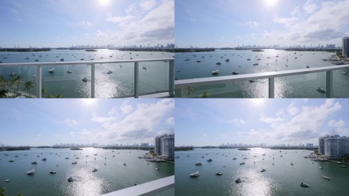 从豪华多层公寓的昂贵阁楼阳台上的早晨视图迈阿密市中心。芙蓉岛、棕榈岛和星岛的美景，还有很多船