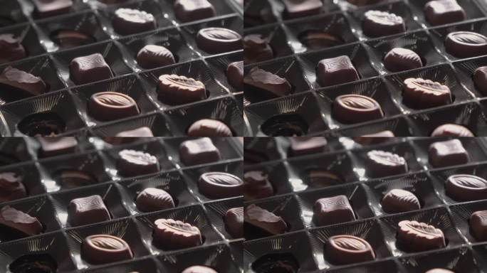 盒子里有各种形状的巧克力糖果。选择性对焦，慢动作。