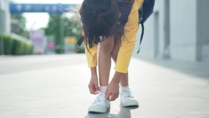 一个小女孩高兴地背着书包，去上学。