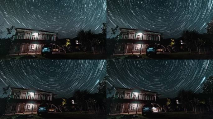 高加索乡村的老房子和繁星点点的天空，上面的光迹用超延时拍摄