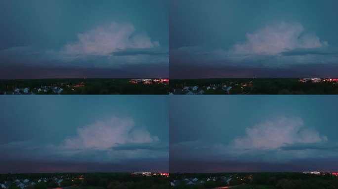 无人机拍摄的暴风雨云形成在阴暗的天空之前，大雨和闪电在郊区城镇地区。