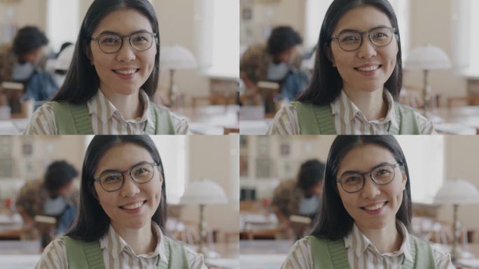 聪明的亚洲女学生的肖像，在高中图书馆看着相机微笑