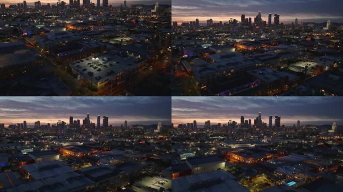 都市夜景鸟瞰图。向上倾斜，市中心的摩天大楼映衬着色彩斑斓的日落天空。洛杉矶，加利福尼亚，美国