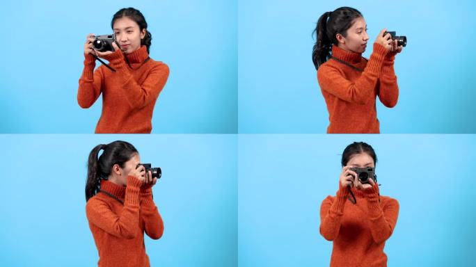 写真女游客的生活方式旅游理念，可爱的亚洲年轻摄影师拿着相机在摄影棚后台拍照，博主女孩用相机拍照创作旅