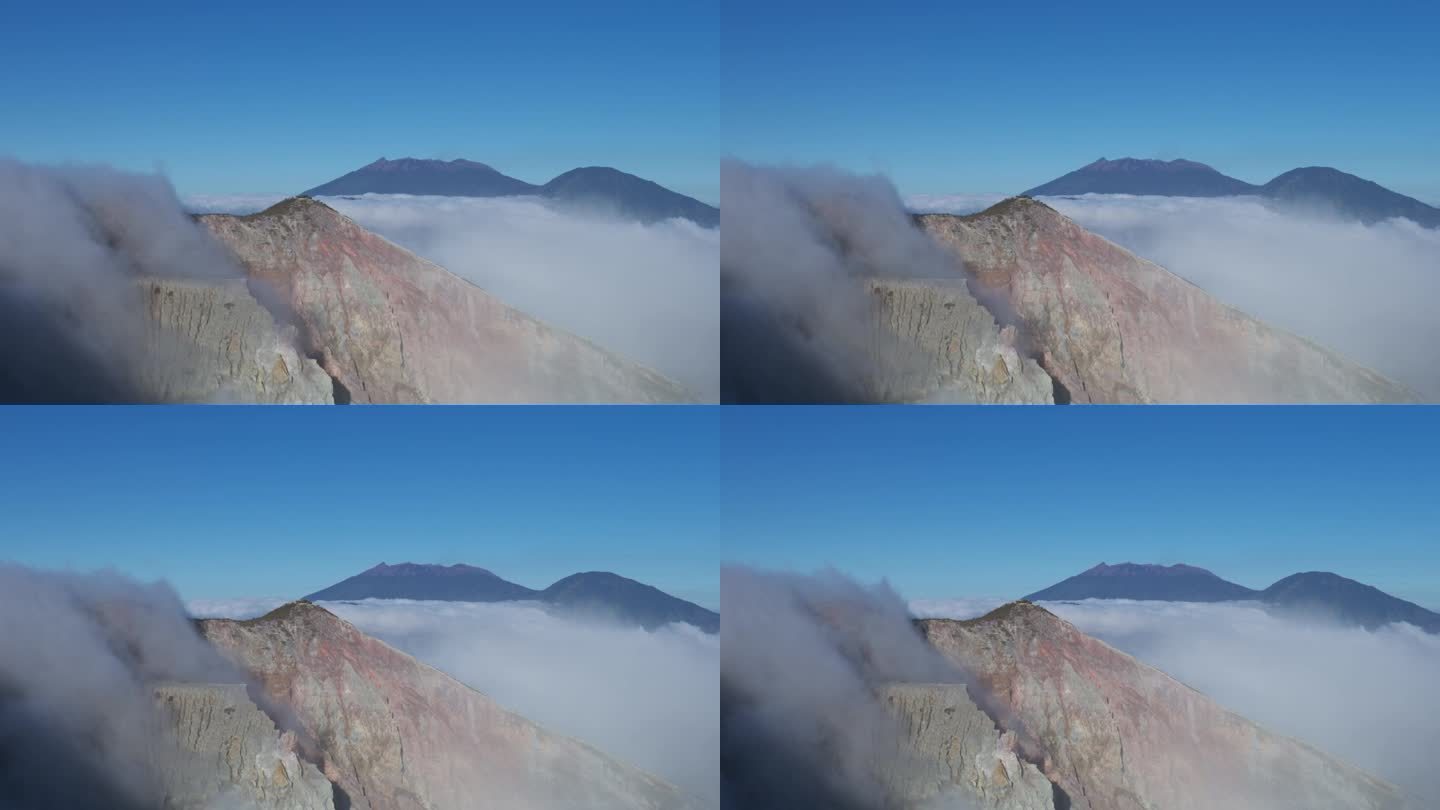 悬崖的云涌入火山的创造者在伊真山，东爪哇，印度尼西亚。蓝天复制空间。