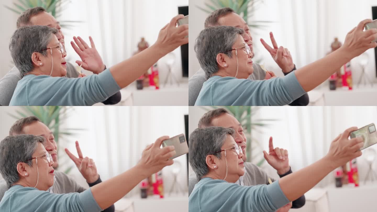 老年夫妇在客厅用平板电脑与朋友或家人进行社交媒体和视频通话，一起享受退休后的生活方式。家庭观念，人寿