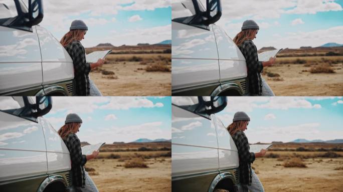 女人看着地图，好像她会和她的露营车在摩洛哥沙漠的某个地方迷路