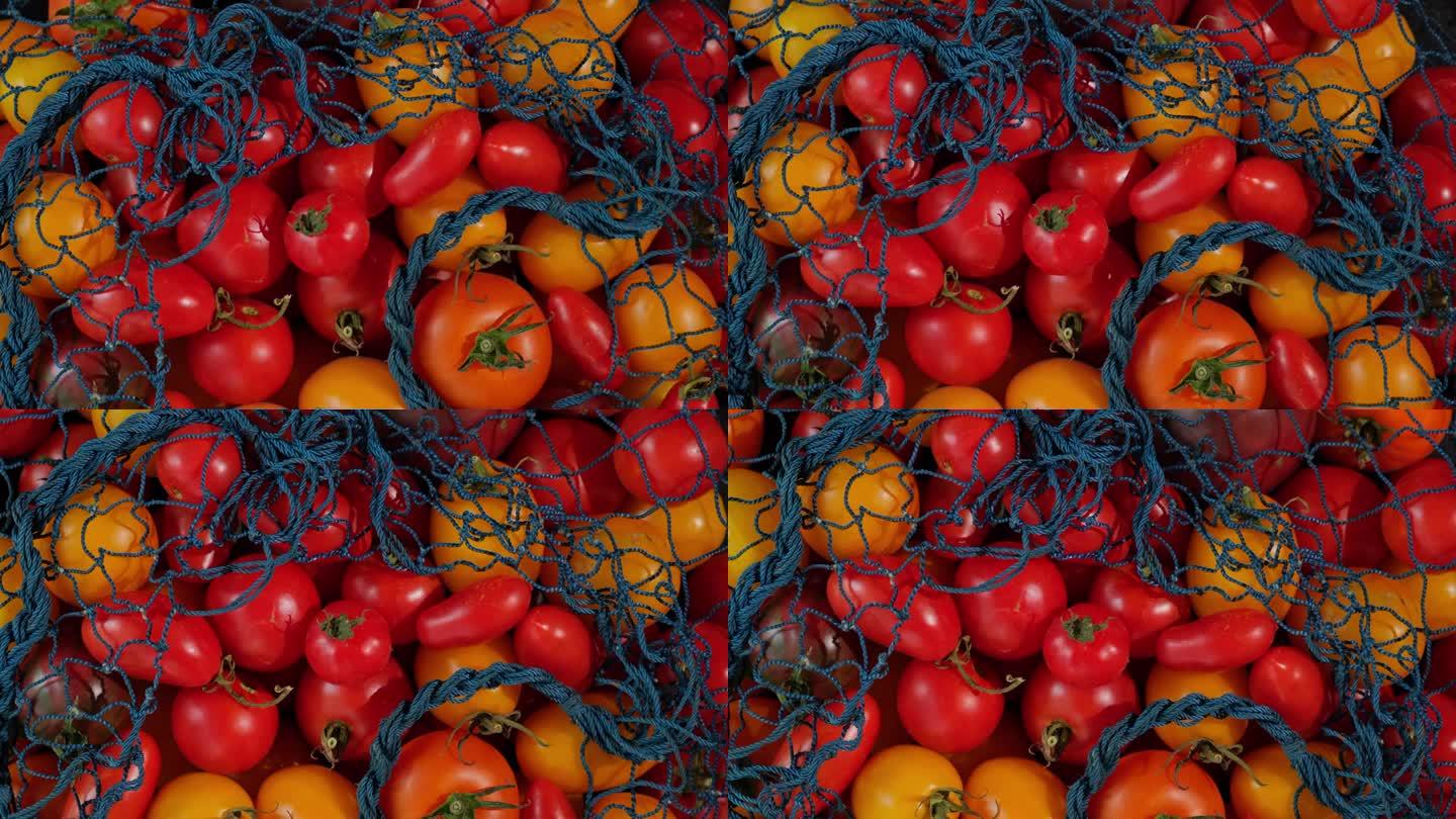 蔬菜成生态绳袋旋转背景。可重复使用的纺织品零废物网袋，黄红色的西红柿