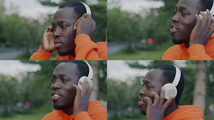 有魅力的非洲裔美国人戴着耳机在城市里听音乐跳舞的特写