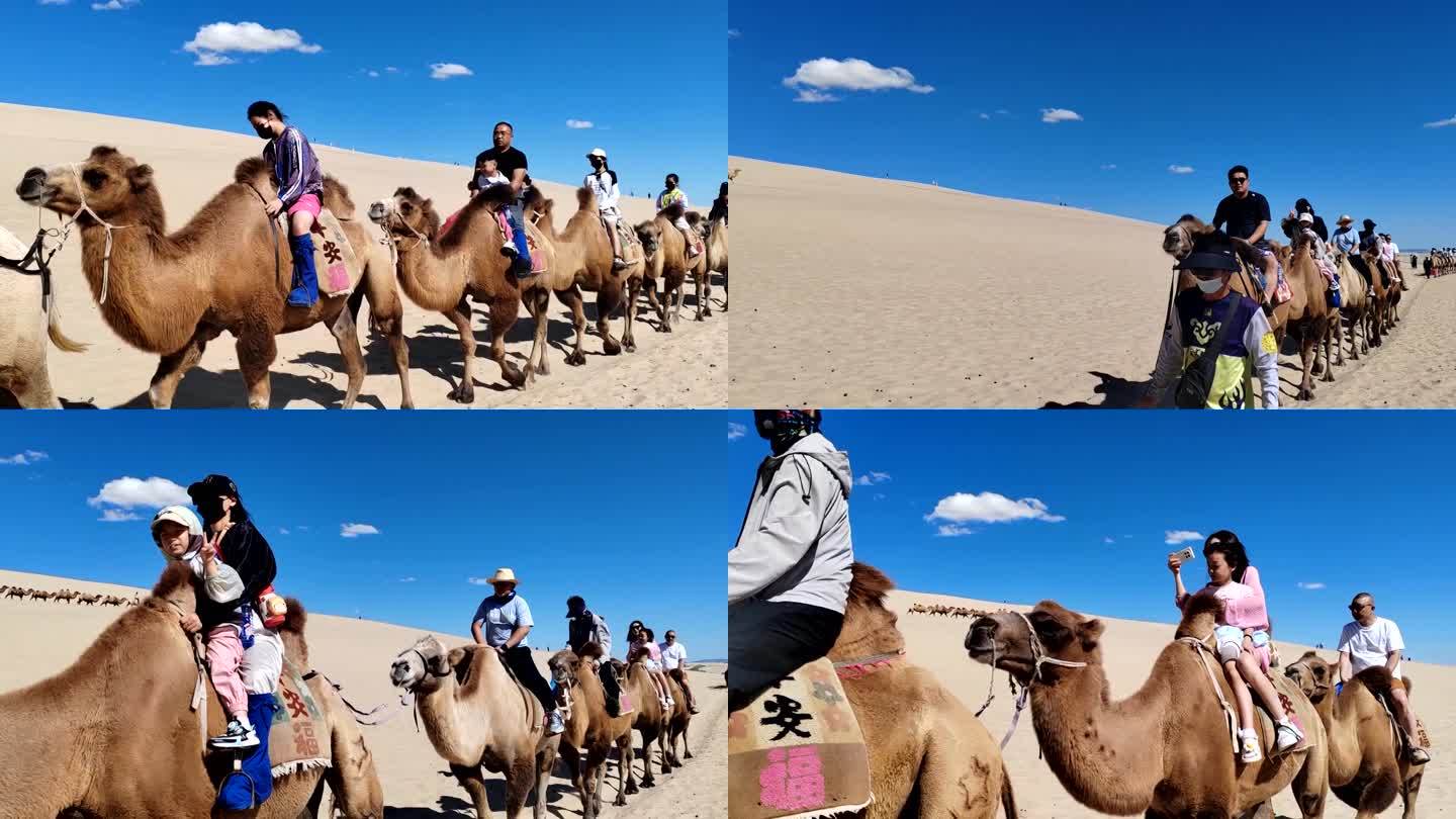 在沙漠旅游区骑骆驼的游客排成排