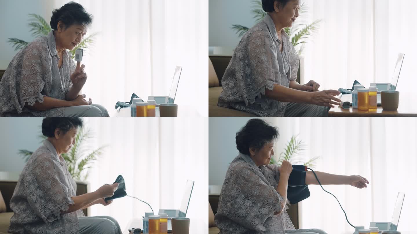 一位老年妇女坐在家里用电子眼压计测量自己的血压和心率。
