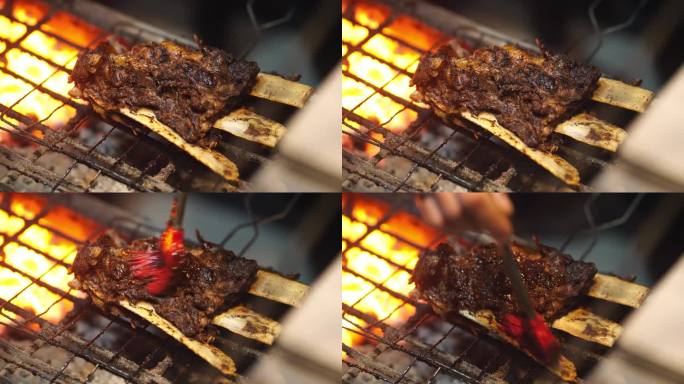 大排骨在传统炭火上的烧烤过程特写。开胃的印尼菜。