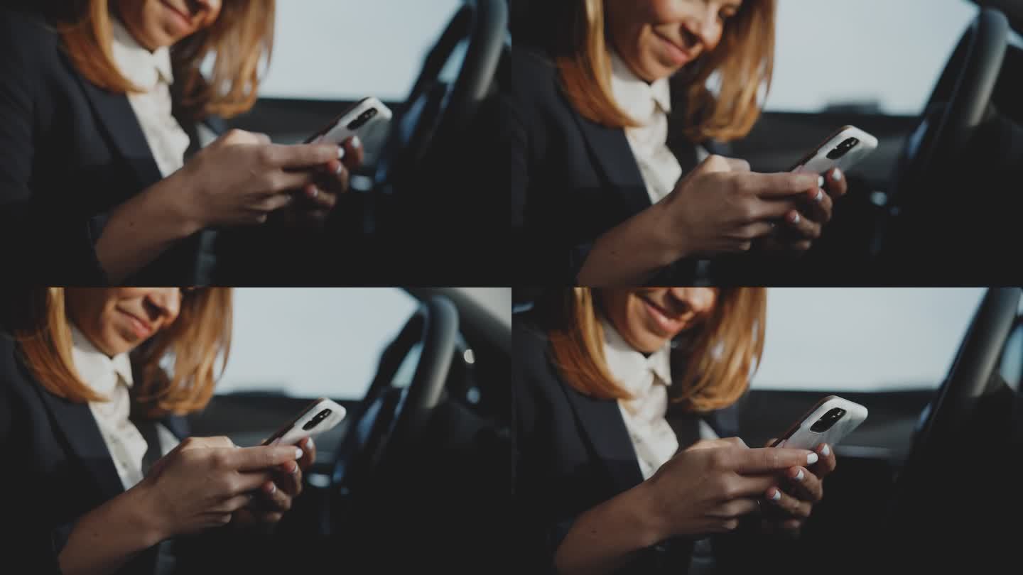 特写一名女子在停着的车里使用智能手机