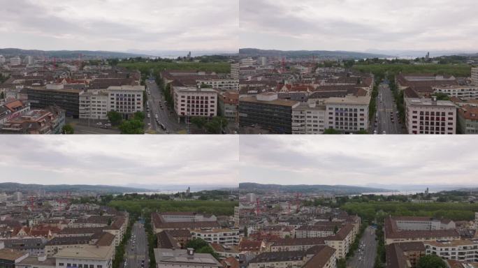 阴天在城市的各种建筑物上空飞行。沿街的多层公寓楼。瑞士苏黎世