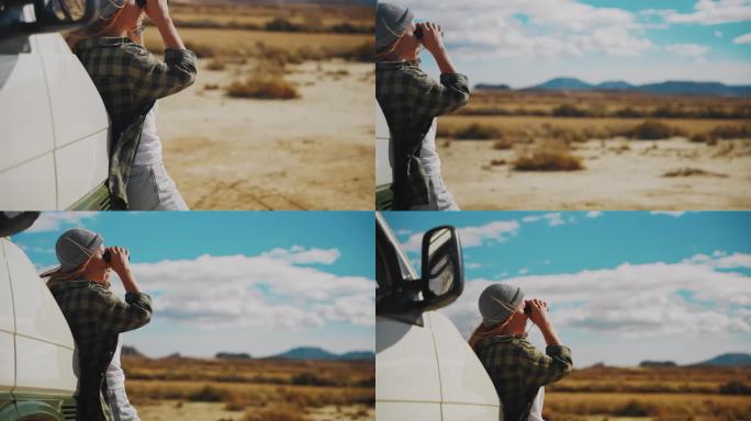 一名女子用双筒望远镜探索摩洛哥某地的沙漠