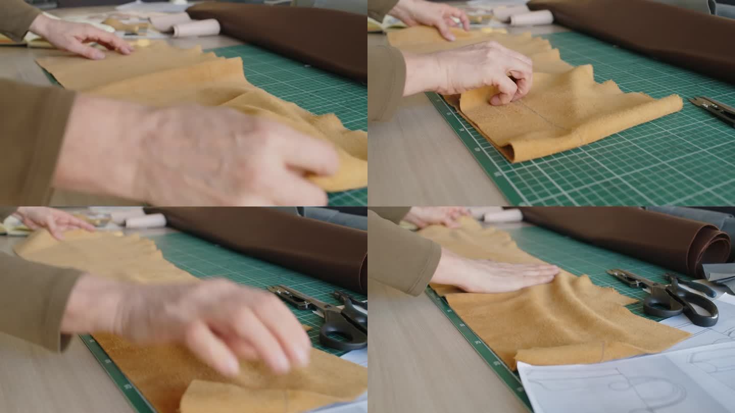 女手袋设计师的手在工作台上摆着一块麂皮