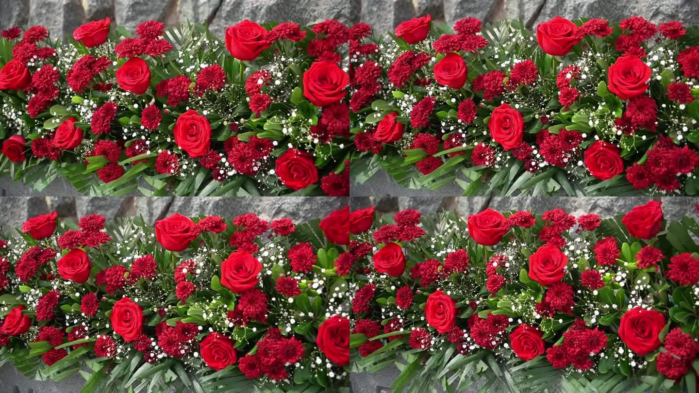 红色的花朵与绿色的刺绣组成，美丽的花束，雏菊和玫瑰