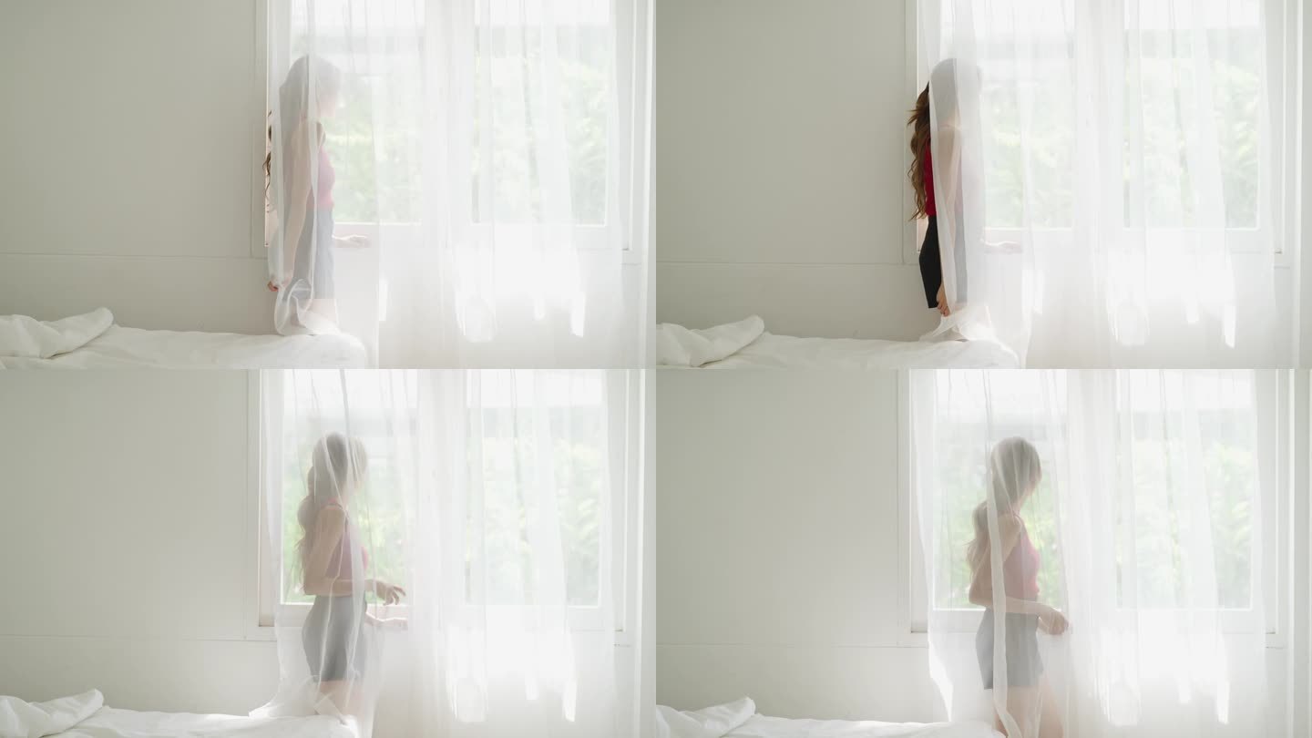 忧郁的亚洲女人站在卧室的窗边哭泣。