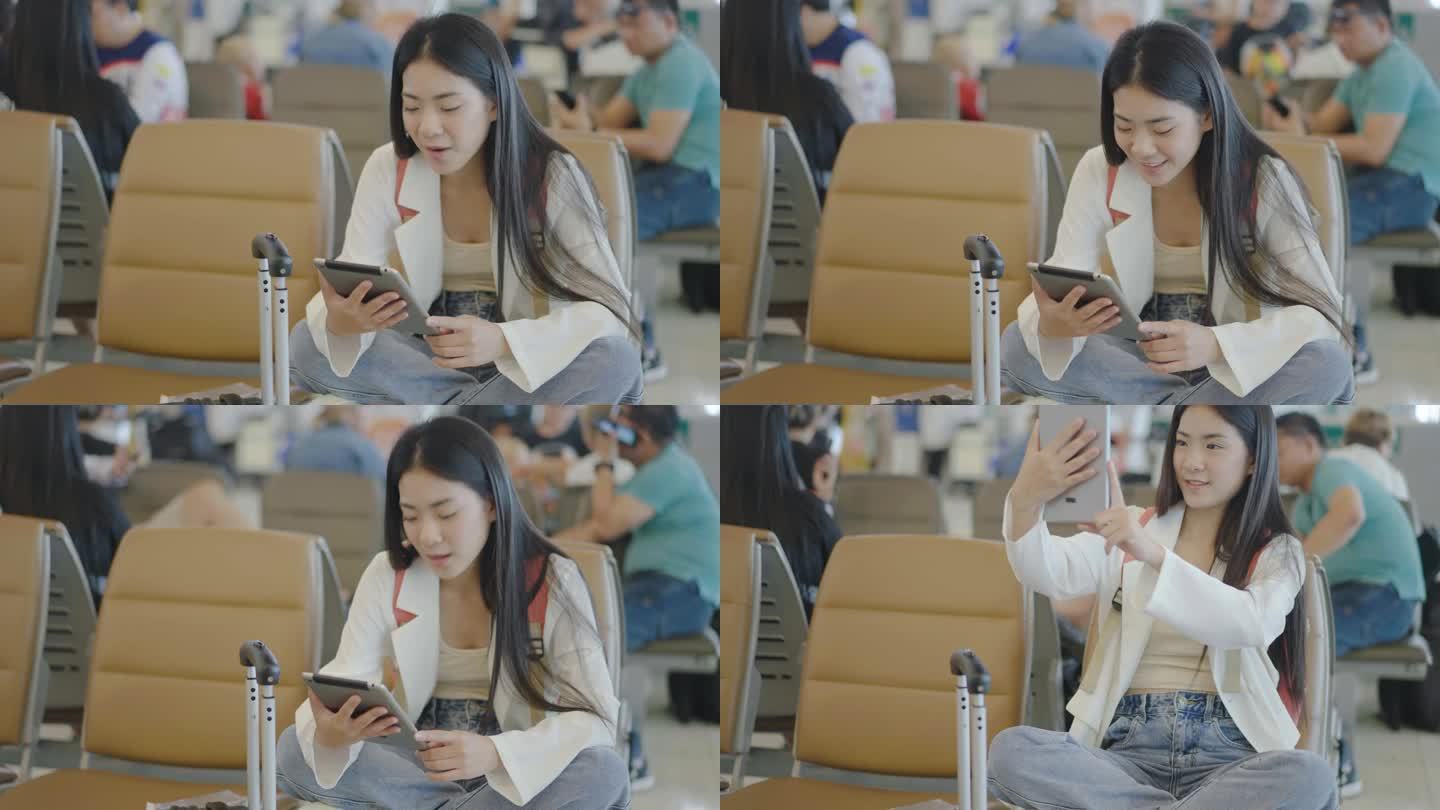 迷人的亚洲年轻女性旅客坐在机场候机口的座位上，通过平板电脑与朋友或家人进行视频通话。