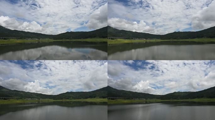 山间坝子中的湖泊倒映着蓝天白云的延时视频