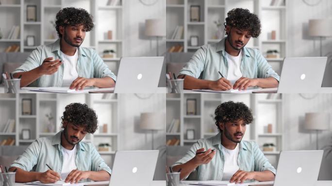 晚上，留胡子的印度男商人正坐在客厅的笔记本电脑前学习。一个年轻人认真地听着视频会议，在笔记本上记下信