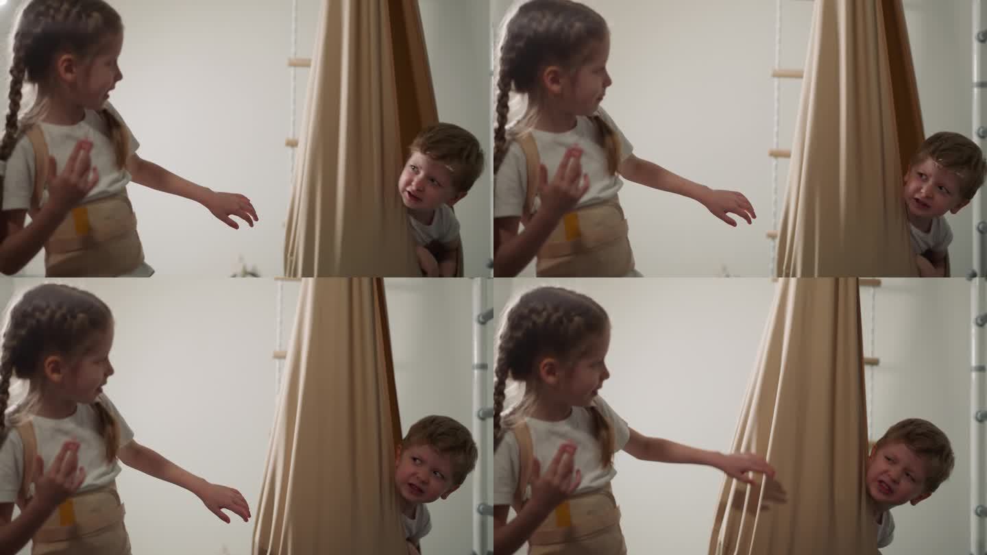 生气的小男孩让妹妹躲在吊床上走开
