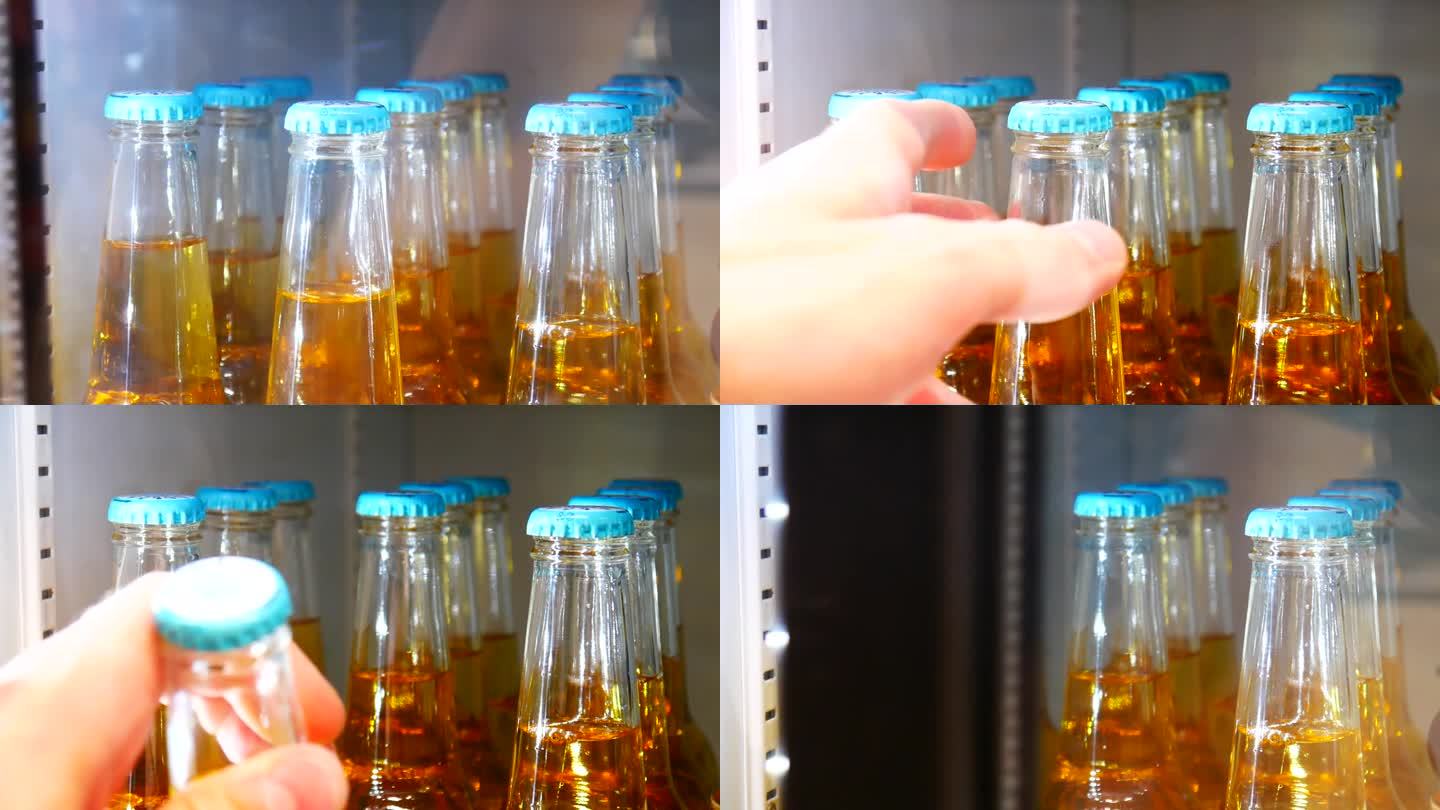 冰箱里装着金色窖藏啤酒的玻璃瓶特写，一只男性的手打开门，拿了一瓶