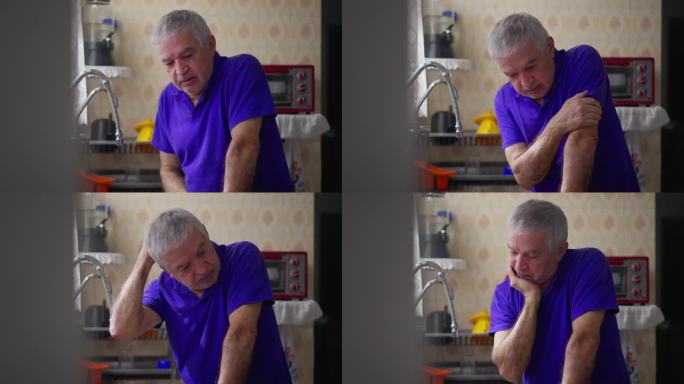 焦虑的老人倚在厨房的水槽上，患有精神疾病。白发老人独自在家与疾病作斗争