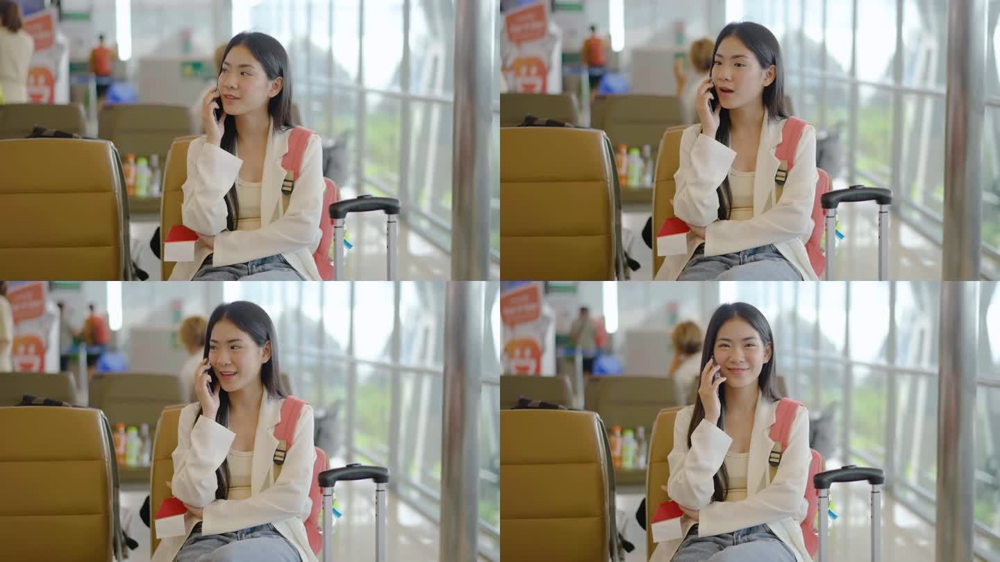 微笑的年轻亚洲女子坐在候诊室里，用智能手机与朋友或家人聊天。美丽的女旅客在机场休息室打电话。电话里的