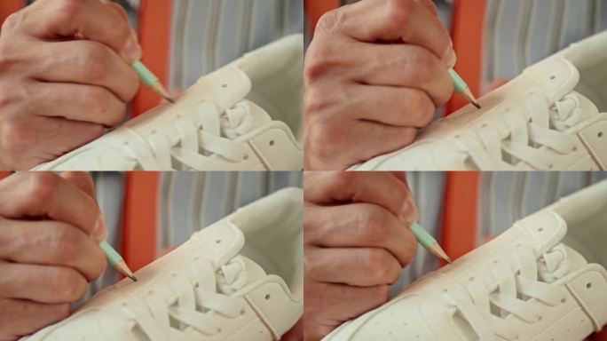 男创意设计师在白色运动鞋上作画